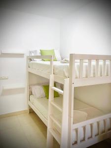 a bedroom with two bunk beds in a room at Nuestro Rincón en la Playa, Golf y Piscina driver in Torre de Benagalbón