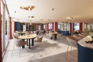 a restaurant with tables and chairs and windows at Roannay - Francorchamps in Francorchamps