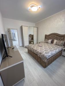 a bedroom with a large bed and a television at Furtuntec in Tecuci