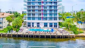 a resort with a dock with chairs and a pool at BeachWalk 1B-1B Apmt Amazing View 12A in Hallandale Beach