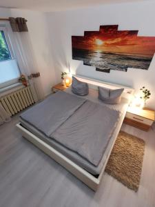 a bed in a bedroom with a tv on the wall at Fewo Krysik Unterdeck in Lühmannsdorf