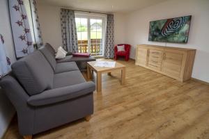 a living room with a couch and a coffee table at Ferienhof Steinmüller in Bad Hindelang