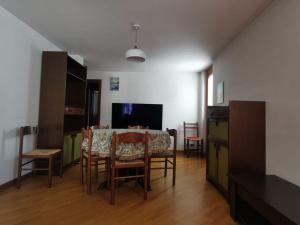 a living room with a dining room table and chairs at Homey Apartment in the heart of Cervinia in Breuil-Cervinia