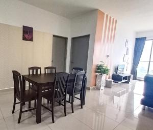 a dining table and chairs in a living room at Homestay at Palas Horizon with sunrise view in Brinchang