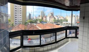 - une vue sur la ville depuis la fenêtre d'un bâtiment dans l'établissement Apartamento com Varanda e Suíte Enseada Guarujá, à Guarujá
