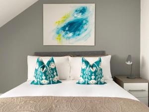 a bedroom with a bed with blue and white pillows at Stanhope Road in South Shields