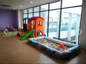 a childrens play room with a sandbox and a pool at UMMI GUESTROOM in Kota Bharu