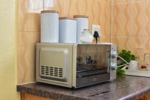 a microwave sitting on top of a kitchen counter at LEMEK Heights in Ga-Mothiba