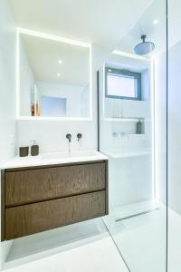 a bathroom with a sink and a shower at Verbier Village Levron 3br chalet large terrace facing south in Levron