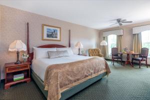 a hotel room with a large bed and a desk at Bar Harbor Grand Hotel in Bar Harbor