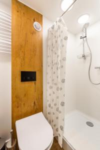 a bathroom with a toilet and a shower at National Stadium Cosy Studios in Warsaw