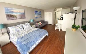 a bedroom with a bed and a living room at Castaways Resort Studios in Daytona Beach