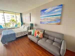 a living room with a couch and a bed at Castaways Resort Studios in Daytona Beach