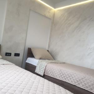 a bedroom with two beds and a window at Gas Otel in Belgrade