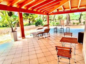 a patio with benches and tables and a pavilion at Villa Costanza in Bari