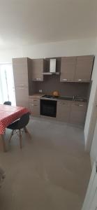 a kitchen with a table and a stove top oven at Il salice in Monte San Savino