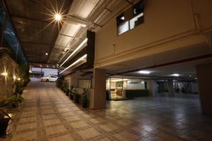 an empty lobby of an office building with plants at Royal Plaza Suites in Mangalore