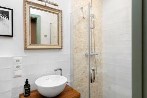 a bathroom with a sink and a shower at La AMARA Farah - en el casco antiguo de Frigiliana in Frigiliana