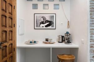 a room with a white counter with a picture on the wall at La AMARA Farah - en el casco antiguo de Frigiliana in Frigiliana