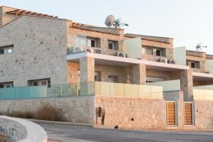 a man standing in front of a building at Philip Seafront Suite! in Panormos Rethymno