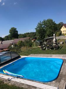 a blue swimming pool sitting next to a car at Baráček–Český ráj in Turnov