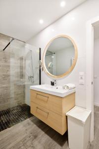 a bathroom with a sink and a mirror at TuApartamento Navarreria Loft in Pamplona