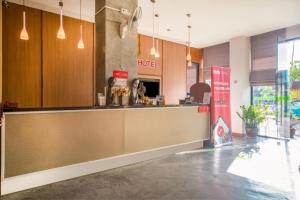 a restaurant lobby with a counter and a bar at I Dee Hotel Patong in Patong Beach