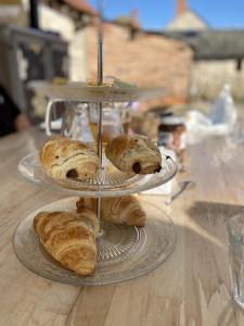 a couple of plates of pastries on a table at 1 Bedroom Tranquil Cottage Fishing by the lake in Bommiers