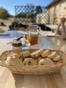 a basket of bread sitting on a table at 1 Bedroom Tranquil Cottage Fishing by the lake in Bommiers