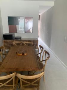 a wooden table with chairs and a shoe on it at BEACH HOUSE - PREÁ,JERI- Cruz,ce in Prea