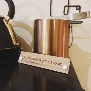 a pot sitting on top of a stove with a sign at The Green Monkey Lux Suite at The Grumpy Schnauzer B&B Private Hot Tub, Gym, Breakfast, Stunning! in New Monkland