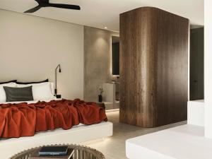 A bed or beds in a room at Magma Resort Santorini, In The Unbound Collection By Hyatt