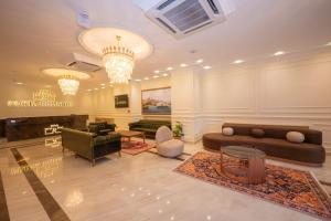 a lobby with a couch and chairs and a table at Porta Romanos Hotel in Istanbul