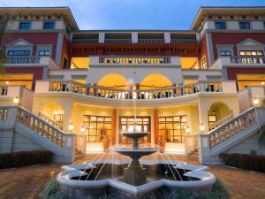 a large building with a fountain in front of it at Lake Victoria Serena Golf Resort & Spa in Kigo