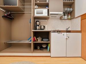 eine Küche mit Kühlschrank und Mikrowelle in der Unterkunft Holiday Home Talvitähti c 37 by Interhome in Ruka + 6 Fotos