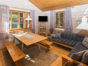 a living room with a couch and a table at Holiday Home Ruka-linkki 3a by Interhome in Ruka