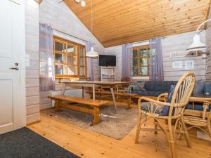 a living room with a table and a couch at Holiday Home Ruka-linkki 3a by Interhome in Ruka