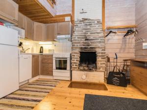 a kitchen with a stone fireplace in a room at Holiday Home Ruka-linkki 3a by Interhome in Ruka