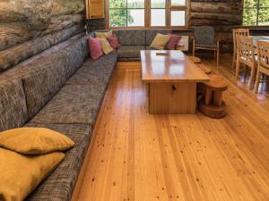 a living room with a couch and a table at Holiday Home Rantaruka 2c3 by Interhome in Ruka