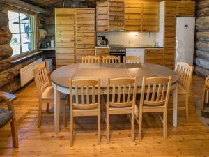 a kitchen and dining room with a table and chairs at Holiday Home Rantaruka 2c3 by Interhome in Ruka
