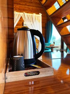 a tea kettle in a wooden box on a table at Kabak Armes Hotel in Faralya