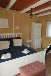 a bedroom with a bed and a cross on the wall at Szitakötő vendégház in Mártély