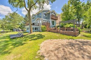 a large blue house with a large yard at Lakefront Oasis with Boat Dock, Fire Pit, Grill in Bristol