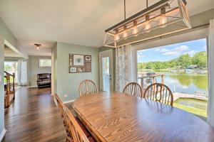 a dining room with a table and a large window at Lakefront Oasis with Boat Dock, Fire Pit, Grill in Bristol