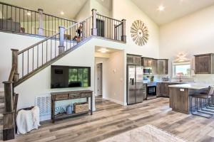 a kitchen and living room with a staircase and a fireplace at Red Lodge Home with Patio about 1 Mi from Downtown! in Red Lodge