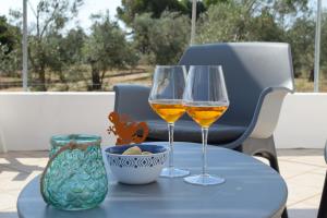 two glasses of wine sitting on a table at Mamma Maria Salento - Alle Macchie in Marina di Pescoluse