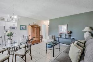 a living room with a couch and a table at Idyllic condo with brief walk to beach and restaurants in Marco Island