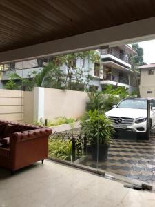 a living room with a couch and a car outside at Hotel Centro in Calangute