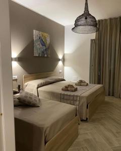 sypialnia z 2 łóżkami i lampką w obiekcie The Dream B&B w mieście Belvedere Marittimo