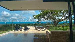 a patio with a table and chairs and a view of the ocean at LoftMerak in Pereira